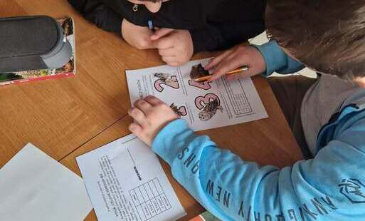 Uczniowie rozwiązujący kartę pracy.